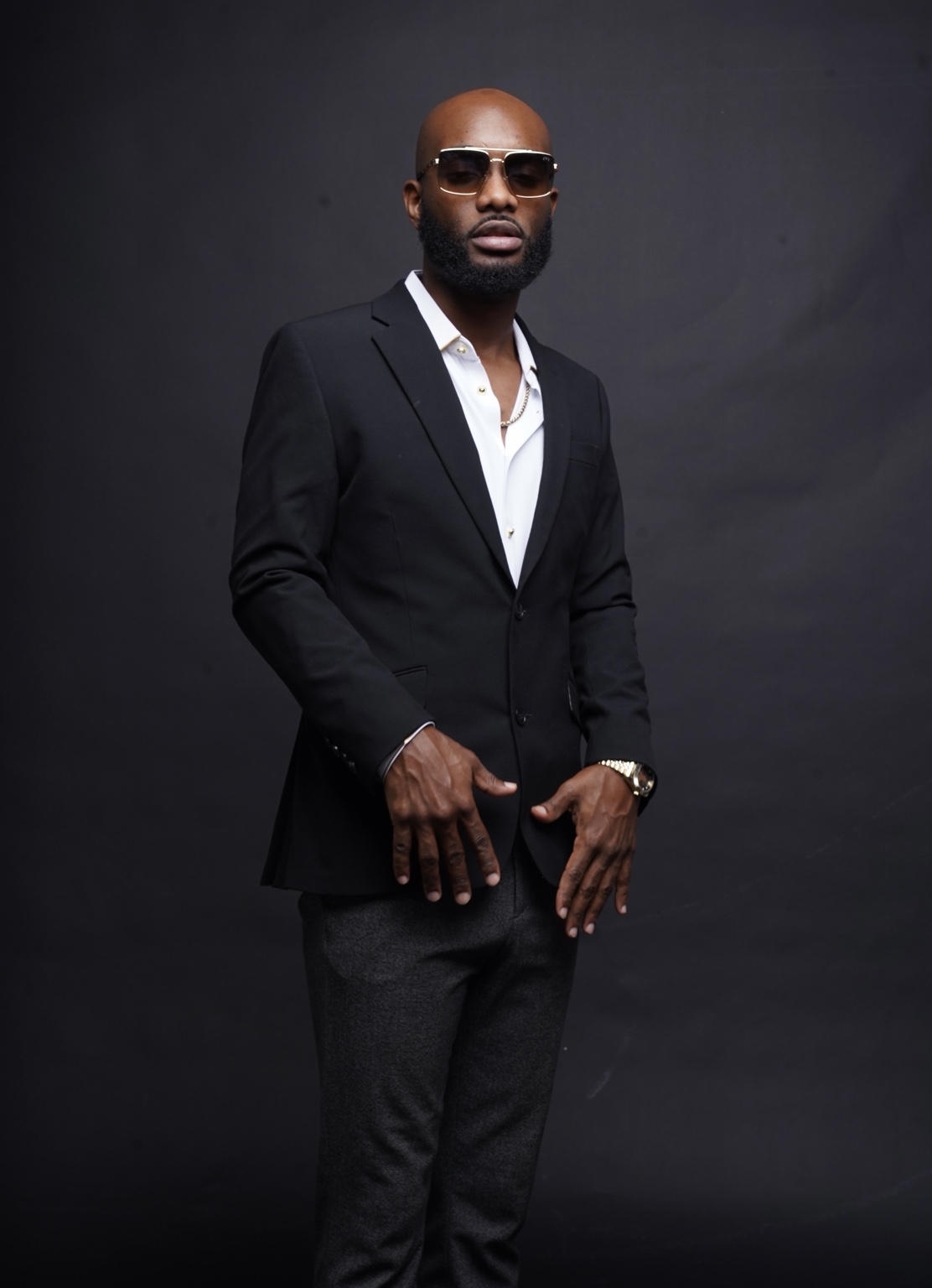 Radio Jamez studio portrait wearing a black blazer and sunglasses